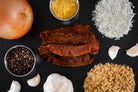 sergeant pepper uncured bacon jerky surrounded by ingredients on a dark slate background