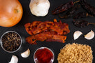smokehouse uncured bacon jerky surrounded by ingredients on a dark slate background